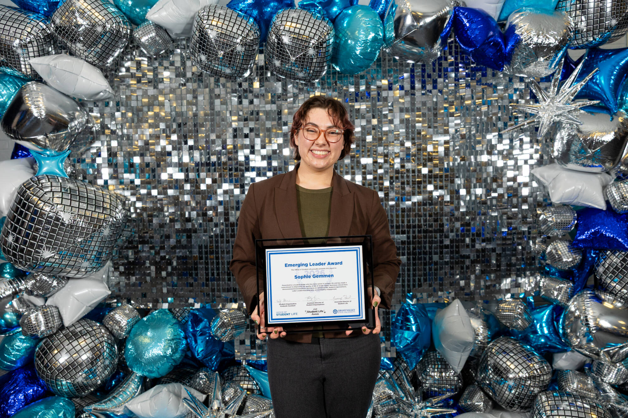 An individual holding an award certificate
